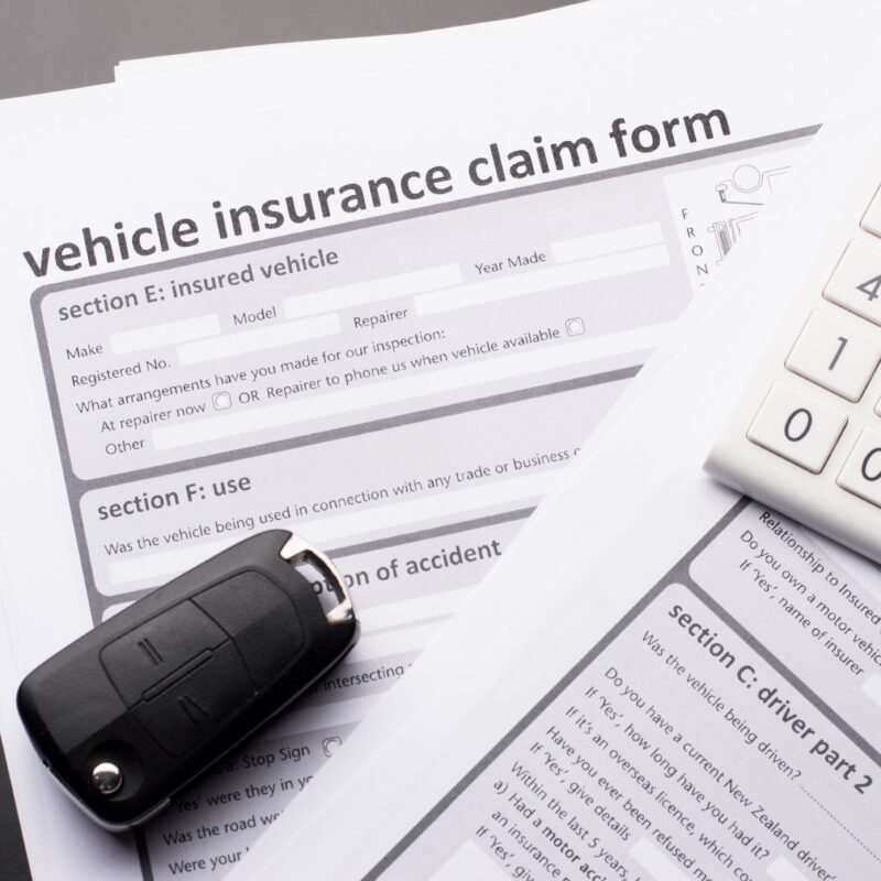 insurance claim form, key fob and calculator for car insurance claim