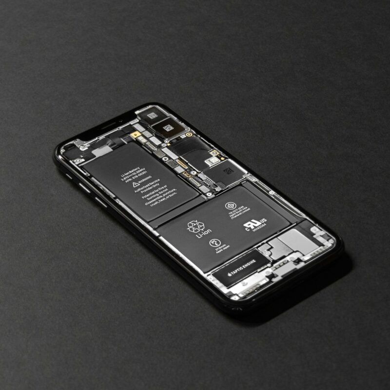 An opened smartphone showing its lithium-ion battery and internal components